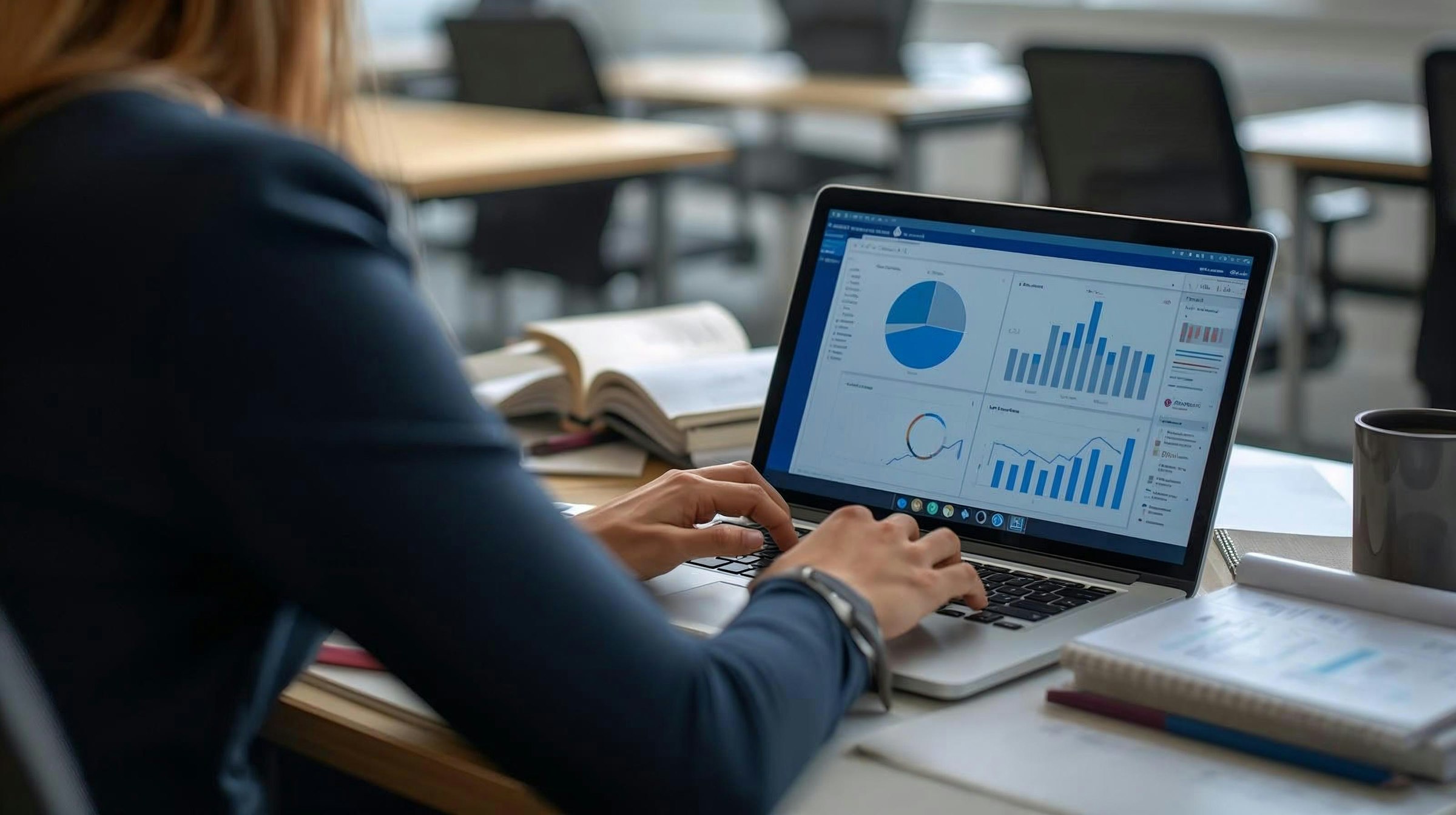 A professional reviewing a clear strategy report with charts on a laptop